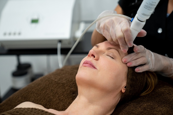 Woman receiving UltraClear laser treatment - AestheteMed